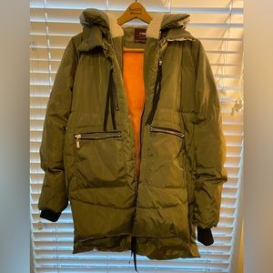 Stylish olive green puffer, orange interior and Sherpa lined hood!